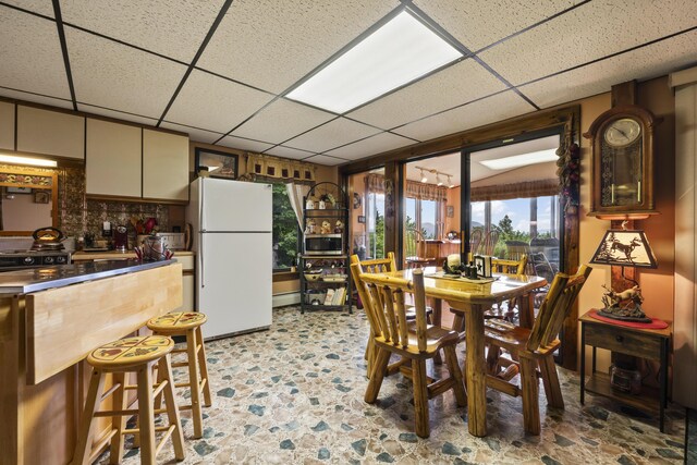 dining area with a paneled ceiling