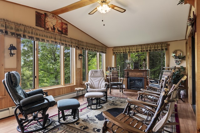 living room with a fireplace, lofted ceiling with beams, a baseboard heating unit, a ceiling fan, and wood finished floors