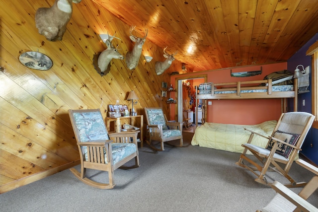 carpeted bedroom featuring wood walls and wooden ceiling