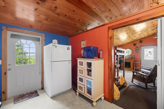 kitchen with white refrigerator, wood ceiling, and light carpet