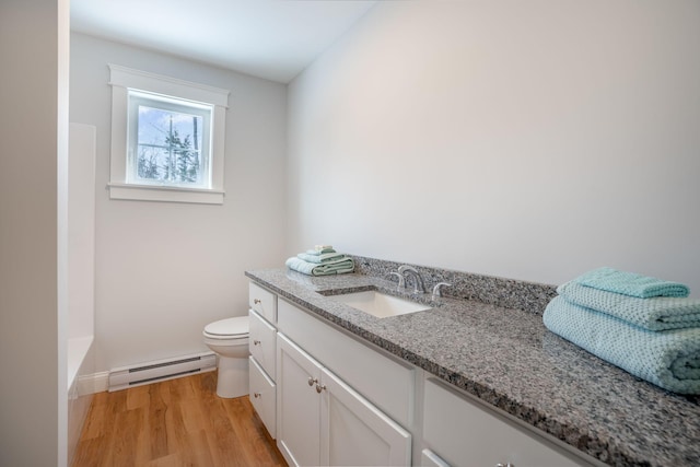 bathroom with hardwood / wood-style flooring, vanity, a baseboard radiator, and toilet