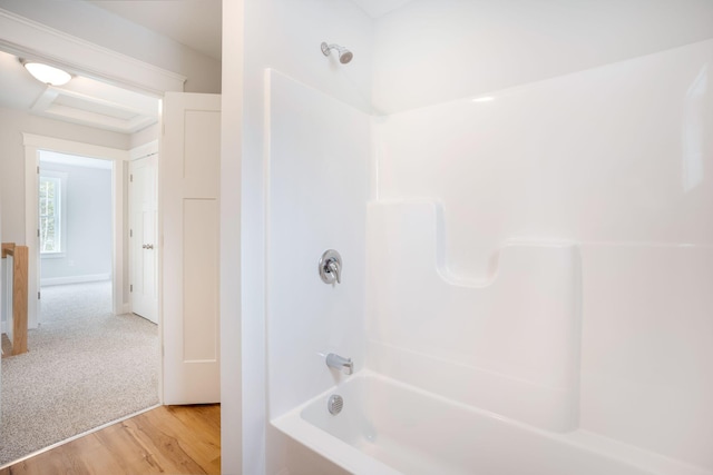 bathroom with hardwood / wood-style flooring and bathtub / shower combination