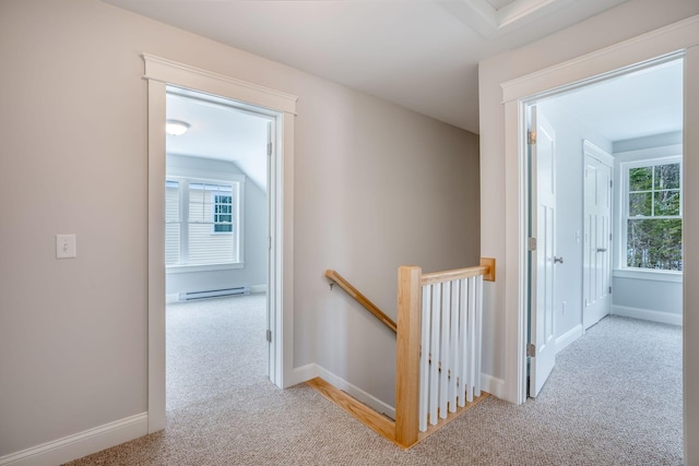 hall with a baseboard radiator, light carpet, and lofted ceiling