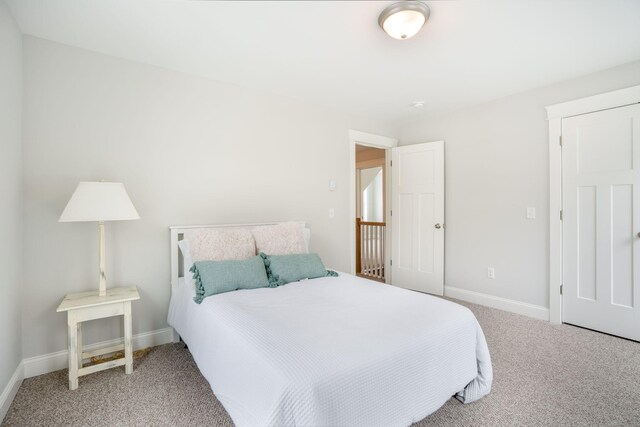 bedroom featuring light colored carpet