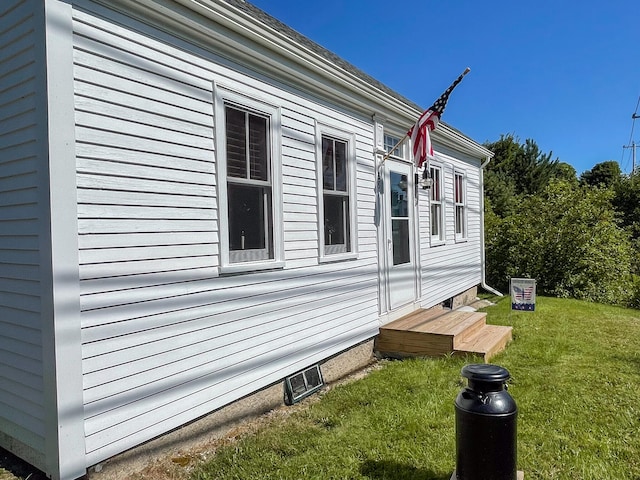 view of side of home with a lawn