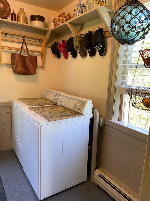 laundry room with washer and clothes dryer, baseboard heating, and a healthy amount of sunlight