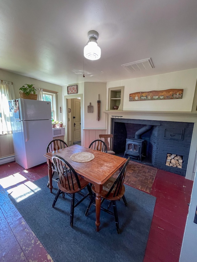 dining area featuring a wood stove