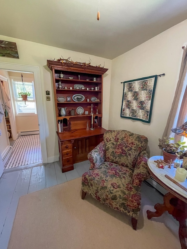 sitting room featuring a baseboard heating unit