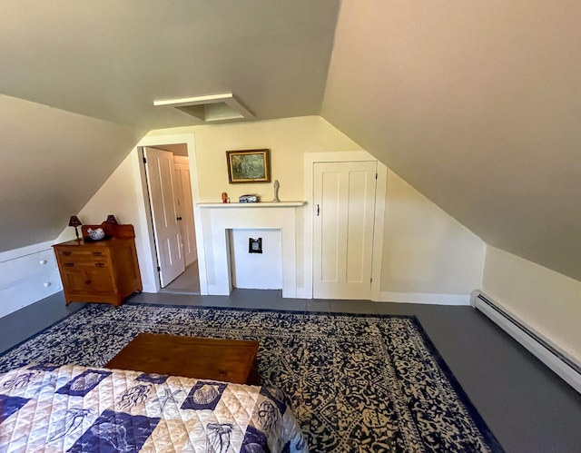 bedroom featuring a baseboard heating unit and vaulted ceiling