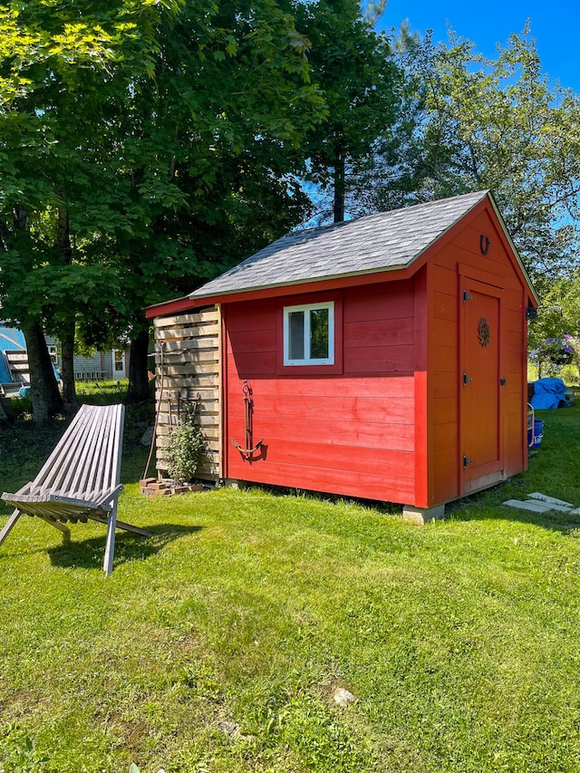 view of outbuilding featuring a lawn