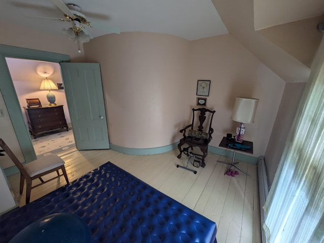 bedroom featuring ceiling fan, vaulted ceiling, and light wood-type flooring