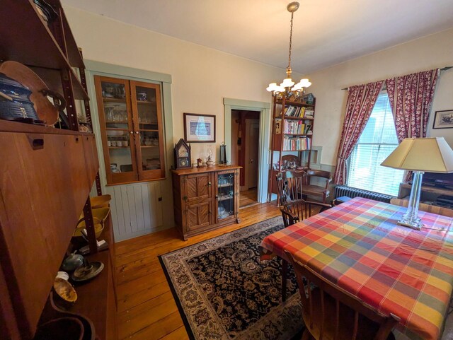 dining room with an inviting chandelier and hardwood / wood-style floors