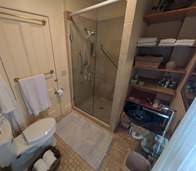 bathroom with toilet, an enclosed shower, and tile patterned floors