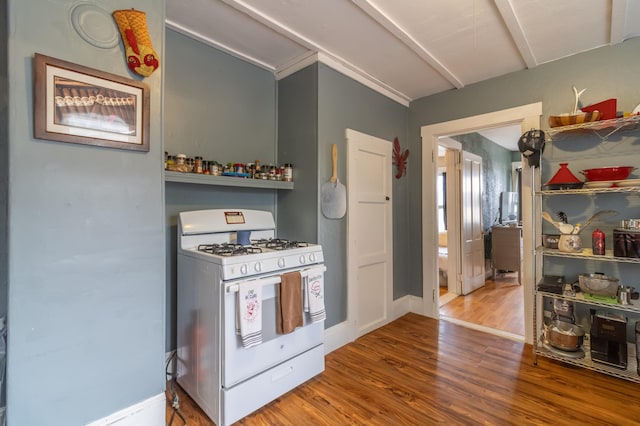 kitchen with white gas range oven and wood-type flooring