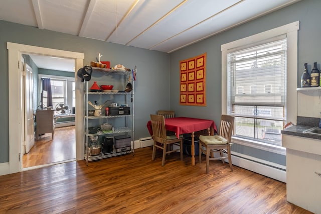 dining area with hardwood / wood-style flooring and baseboard heating