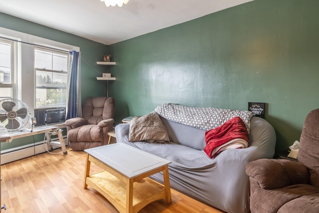 living room with light hardwood / wood-style floors and baseboard heating