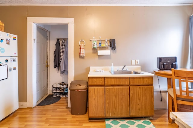 interior space featuring a textured ceiling, hardwood / wood-style flooring, and vanity