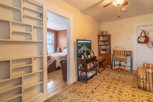 interior space with ceiling fan and wood-type flooring