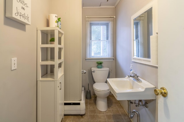 bathroom with tile patterned floors, ornamental molding, sink, and toilet