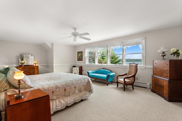 carpeted bedroom featuring baseboard heating and ceiling fan