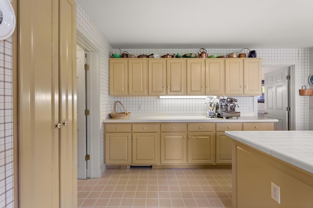 kitchen featuring tile countertops, backsplash, and light tile patterned floors