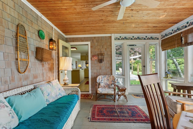 sunroom / solarium with ceiling fan and wooden ceiling