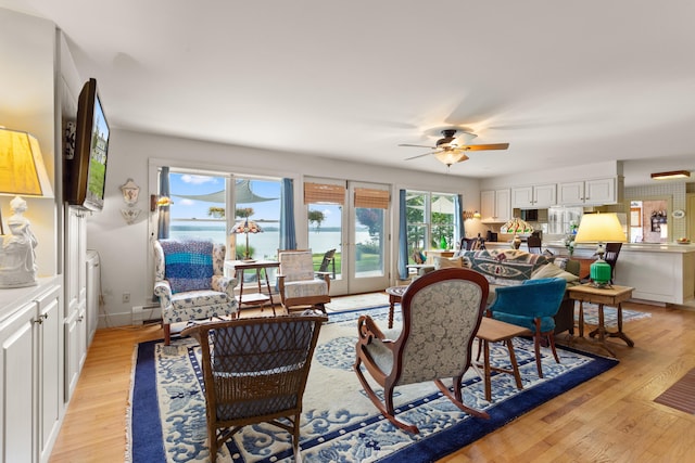 living room with ceiling fan, french doors, and light hardwood / wood-style floors