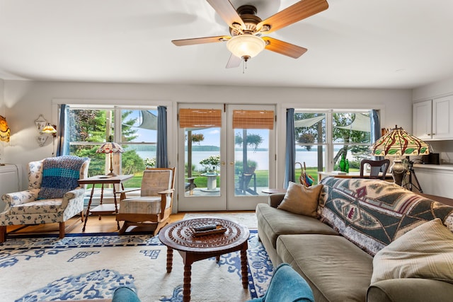 living room with ceiling fan, light hardwood / wood-style floors, and a wealth of natural light