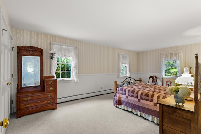 carpeted bedroom with a baseboard radiator and multiple windows