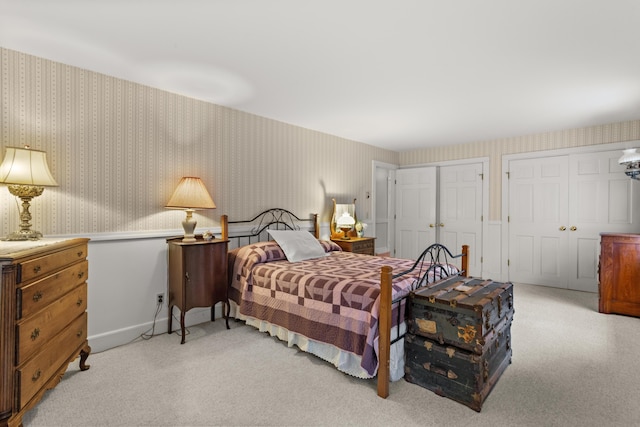 carpeted bedroom featuring two closets