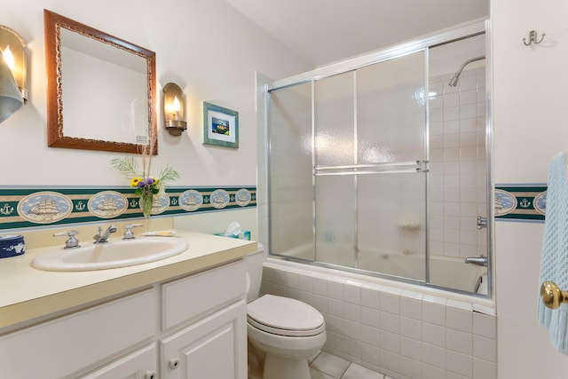 full bathroom with shower / bath combination with glass door, vanity, and toilet