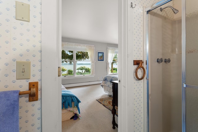 bathroom featuring a baseboard heating unit and a shower with shower door