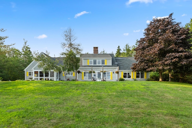 view of front of house with a pergola and a front yard