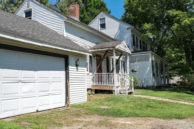 view of front of property with a front lawn and a garage