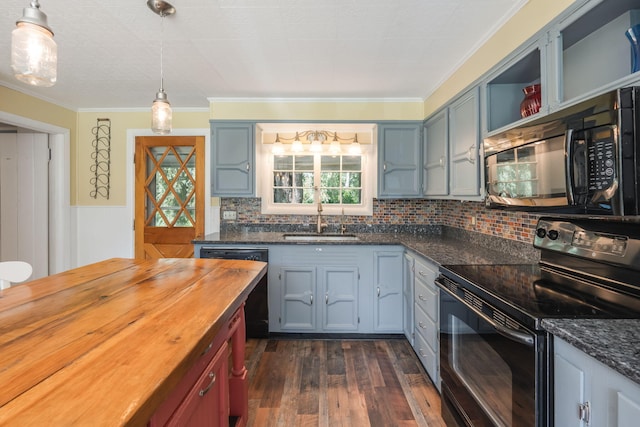 kitchen featuring dark wood-type flooring, sink, tasteful backsplash, black appliances, and butcher block countertops