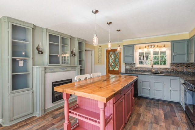 kitchen featuring decorative backsplash, sink, dark hardwood / wood-style flooring, and crown molding