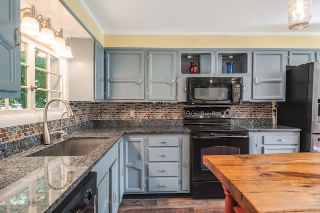 kitchen with dark hardwood / wood-style flooring, decorative backsplash, sink, ornamental molding, and black appliances