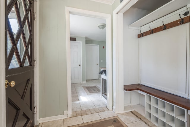 mudroom with ornamental molding and light tile patterned floors