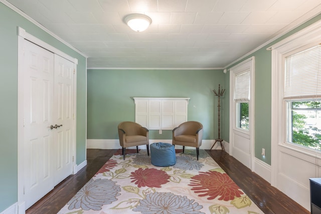 sitting room featuring dark wood-type flooring and ornamental molding