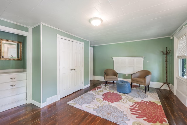 living area with crown molding and hardwood / wood-style flooring