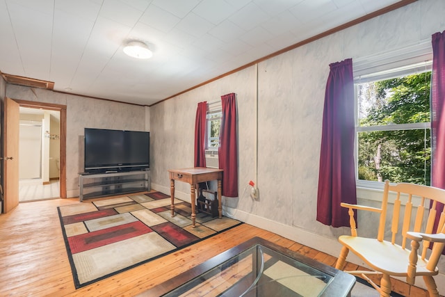 living room with ornamental molding and light hardwood / wood-style floors