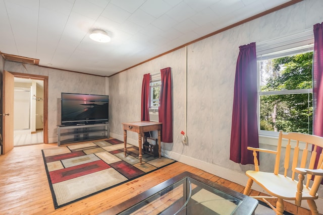 living room featuring light hardwood / wood-style floors and crown molding