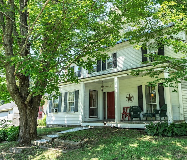 view of front of home featuring covered porch and a front yard