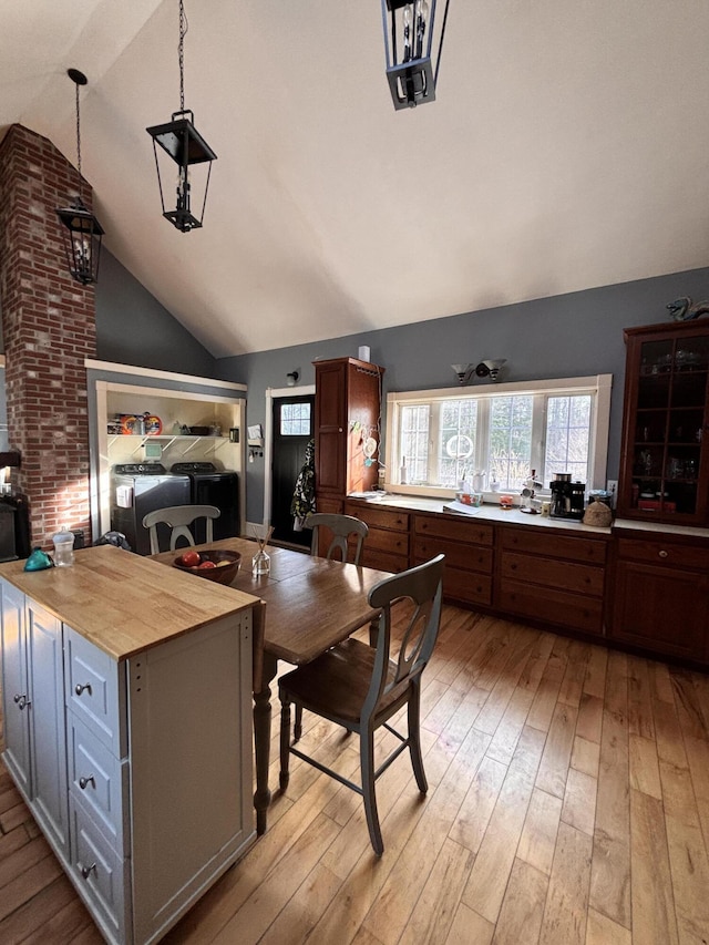 kitchen with wood counters, vaulted ceiling, light hardwood / wood-style flooring, gray cabinets, and pendant lighting