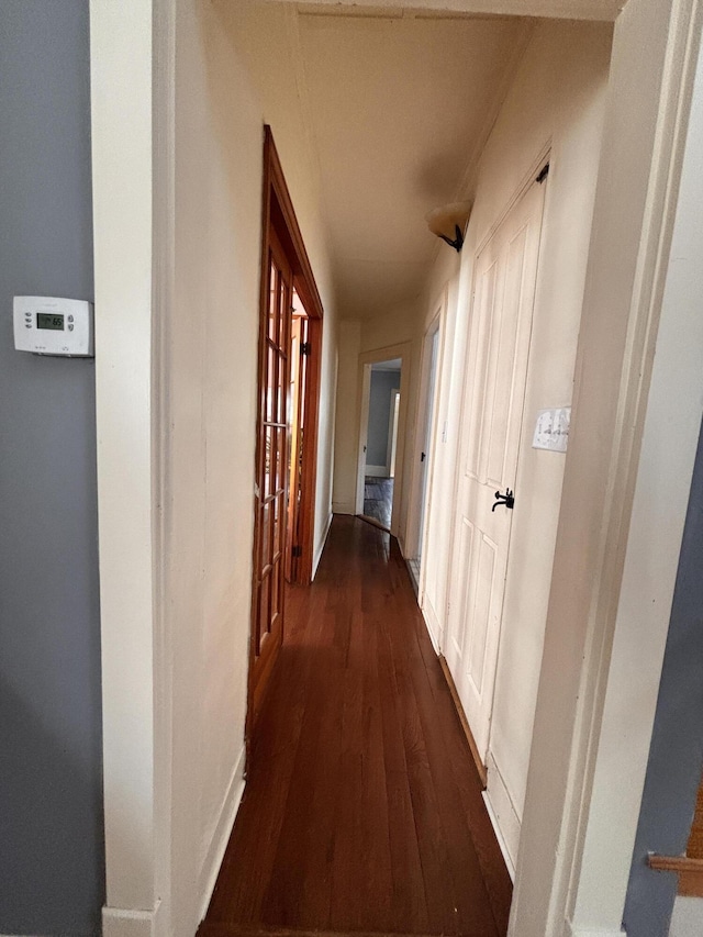 hall with dark hardwood / wood-style flooring