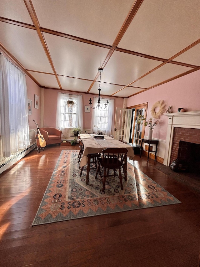 dining space with coffered ceiling, dark hardwood / wood-style floors, and a brick fireplace