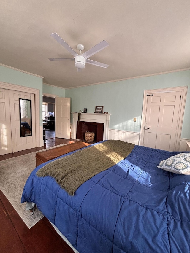 bedroom with ornamental molding, hardwood / wood-style floors, and ceiling fan