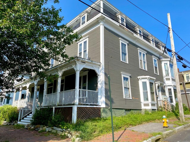 view of side of property featuring a porch