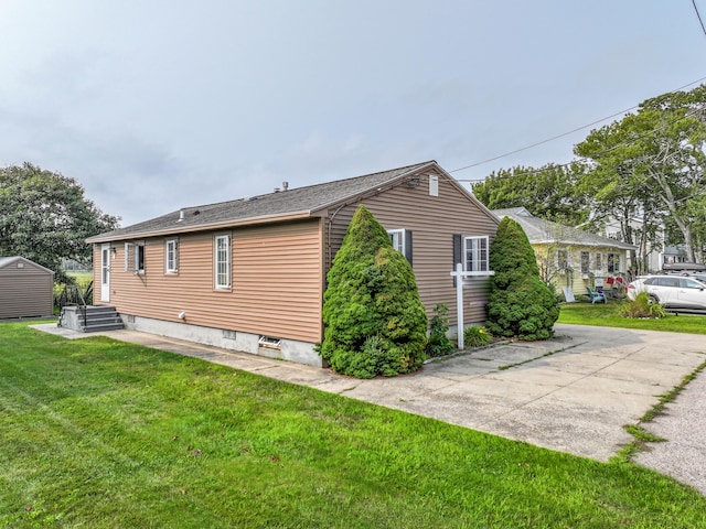 view of side of home featuring a yard