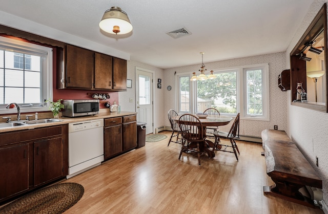 kitchen featuring dishwasher, a chandelier, dark brown cabinetry, sink, and light wood-type flooring